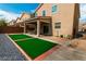 Spacious backyard featuring a patio, turf area, rock landscaping, and plenty of space for outdoor activities at 6412 Dimatteo St, Las Vegas, NV 89148