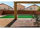 Outdoor patio with a paved patio, turf, privacy fence, and an ideal space for entertaining and relaxing at 6412 Dimatteo St, Las Vegas, NV 89148