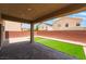 Relaxing covered patio with brick pavers and a small turf area at 6412 Dimatteo St, Las Vegas, NV 89148