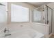 Bathtub and shower with tile surround and glass door at 6412 Dimatteo St, Las Vegas, NV 89148