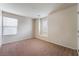 Well-lit bedroom with plush carpeting and windows offering natural light at 6412 Dimatteo St, Las Vegas, NV 89148