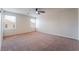 Large carpeted bedroom with two windows and ceiling fan at 6412 Dimatteo St, Las Vegas, NV 89148