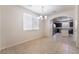 Bright dining room with tile floors leading to an open kitchen with stainless appliances at 6412 Dimatteo St, Las Vegas, NV 89148