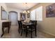 Open dining room with natural lighting, chandelier, and neutral decor, perfect for Gathering meals at 6412 Dimatteo St, Las Vegas, NV 89148