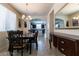 Formal dining room with tile flooring, chandelier, wainscoting and room for hosting dinner parties at 6412 Dimatteo St, Las Vegas, NV 89148