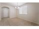 Bright dining room showcasing neutral walls, tile floors, and natural light from the window at 6412 Dimatteo St, Las Vegas, NV 89148
