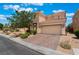 Charming two-story home boasts desert landscaping, a brick-paved driveway, and a two-car garage at 6412 Dimatteo St, Las Vegas, NV 89148