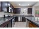 Well-equipped kitchen with stainless steel appliances, granite counters, and dark wood cabinetry at 6412 Dimatteo St, Las Vegas, NV 89148