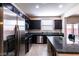 Stylish kitchen featuring stainless appliances, granite countertops, kitchen island with an eat-in breakfast bar at 6412 Dimatteo St, Las Vegas, NV 89148