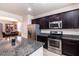 Well-equipped kitchen with an island, stainless steel appliances, granite counters, and ample cabinet space at 6412 Dimatteo St, Las Vegas, NV 89148