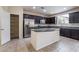Modern kitchen features granite countertops, stainless steel appliances, and a center island at 6412 Dimatteo St, Las Vegas, NV 89148