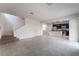 Open-concept living room with stairs, dark cabinetry, tile floors and stainless steel appliances at 6412 Dimatteo St, Las Vegas, NV 89148