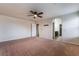 Expansive carpeted main bedroom with ceiling fan and ensuite bathroom at 6412 Dimatteo St, Las Vegas, NV 89148