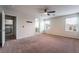 Spacious main bedroom with carpet floors, ceiling fan and ensuite bathroom at 6412 Dimatteo St, Las Vegas, NV 89148