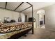 Spacious main bedroom with a four poster bed, walk-in closet, carpet, and an en-suite bathroom at 6412 Dimatteo St, Las Vegas, NV 89148