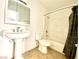 Bathroom featuring a shower-tub combo, toilet, and pedestal sink at 6968 Hopkins Dr, Las Vegas, NV 89156