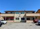 A two-story apartment complex with a parking area in front and an awning on the ground level deck at 6968 Hopkins Dr, Las Vegas, NV 89156