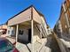 Angled side view of a two-story apartment complex with stucco siding, exterior stair access, and gravel landscaping at 6968 Hopkins Dr, Las Vegas, NV 89156