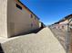 A backyard featuring stucco siding, gravel landscaping, a chain-link fence and a view of the neighboring buildings at 6968 Hopkins Dr, Las Vegas, NV 89156