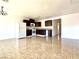 Open-concept kitchen and dining area with tile floors and dark cabinets at 6968 Hopkins Dr, Las Vegas, NV 89156