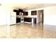 Open kitchen features tile flooring, white appliances, dark wood cabinets, and plenty of natural light at 6968 Hopkins Dr, Las Vegas, NV 89156