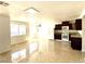 Spacious living room featuring tile floors, updated light fixtures, and natural light at 6968 Hopkins Dr, Las Vegas, NV 89156