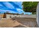 Large backyard featuring a built-in fire pit, storage building, ample open space, and perimeter fencing at 701 Harvard St, Las Vegas, NV 89107
