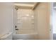 Bathroom featuring a tub/shower combo with white tile surround at 701 Harvard St, Las Vegas, NV 89107