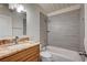 Bathroom featuring a granite vanity, mirror, and shower-over-tub combo with tile surround at 701 Harvard St, Las Vegas, NV 89107