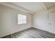 Bedroom featuring gray wood-look flooring, white walls, and natural light from a window at 701 Harvard St, Las Vegas, NV 89107