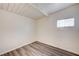 Bedroom with gray wood-look flooring, white walls, and natural light from one window at 701 Harvard St, Las Vegas, NV 89107