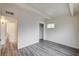 Bedroom featuring gray wood-look flooring, white walls, and a closet storage area at 701 Harvard St, Las Vegas, NV 89107