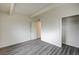 Bedroom with gray wood-look flooring, white walls, and a closet storage area at 701 Harvard St, Las Vegas, NV 89107