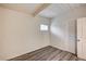 Bedroom featuring gray wood-look flooring, white walls, and natural light from one window at 701 Harvard St, Las Vegas, NV 89107