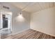 Bedroom featuring gray wood-look flooring, white walls, and adjacent kitchen at 701 Harvard St, Las Vegas, NV 89107