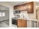 Kitchen featuring wood cabinets, stainless steel appliances, and tiled floors at 701 Harvard St, Las Vegas, NV 89107