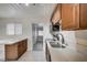 Cozy kitchen with stainless steel sink, modern countertops, and a breakfast bar area at 701 Harvard St, Las Vegas, NV 89107