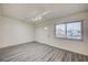 Bright living room featuring wood-look floors, a front door, and a closet at 701 Harvard St, Las Vegas, NV 89107