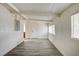 Living room with laminate floors, neutral paint, and view to bathroom at 701 Harvard St, Las Vegas, NV 89107