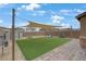 Spacious backyard with artificial turf, a shade sail, a swing set, and a storage shed at 7122 Red Gulch St, North Las Vegas, NV 89084