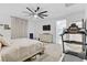 Bright bedroom featuring a white bed frame, dresser, and exercise equipment at 7122 Red Gulch St, North Las Vegas, NV 89084