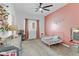 Charming bedroom featuring a pink wall, a small bed, and colorful decor at 7122 Red Gulch St, North Las Vegas, NV 89084