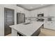 Modern kitchen featuring white cabinets, stainless steel appliances, and an island with a white countertop at 7122 Red Gulch St, North Las Vegas, NV 89084