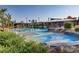 A colorful community splash pad with spray features and shaded seating areas at 7122 Red Gulch St, North Las Vegas, NV 89084