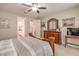 Bright bedroom with neutral walls, ceiling fan, carpet, and en suite bathroom access at 8257 Skye Peak St, Las Vegas, NV 89166