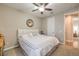 Neutral bedroom featuring a ceiling fan, carpet, window, and a mirrored wall at 8257 Skye Peak St, Las Vegas, NV 89166