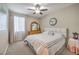 Neutral bedroom featuring a ceiling fan, carpet, window, and a wooden dresser at 8257 Skye Peak St, Las Vegas, NV 89166