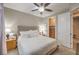 Neutral bedroom with ceiling fan, carpet, bedside tables, and en suite access at 8257 Skye Peak St, Las Vegas, NV 89166