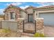 Charming home entrance with a stone facade, iron gate, and warm 'Home Sweet Home' welcome mat at 8257 Skye Peak St, Las Vegas, NV 89166