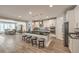 Modern kitchen flows into a dining room and features a large island with countertop seating at 8257 Skye Peak St, Las Vegas, NV 89166